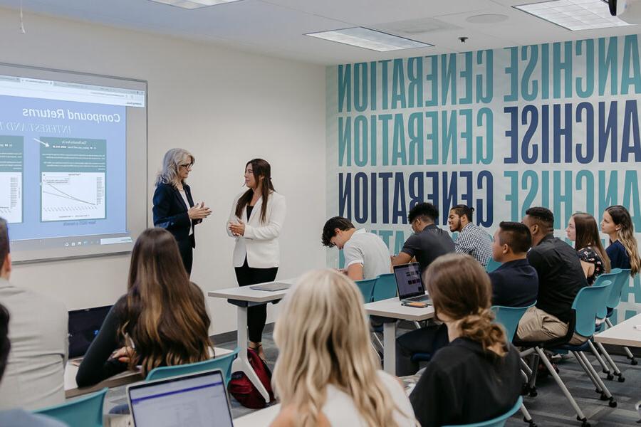 students participating in a classroom lecture with a power point presentation